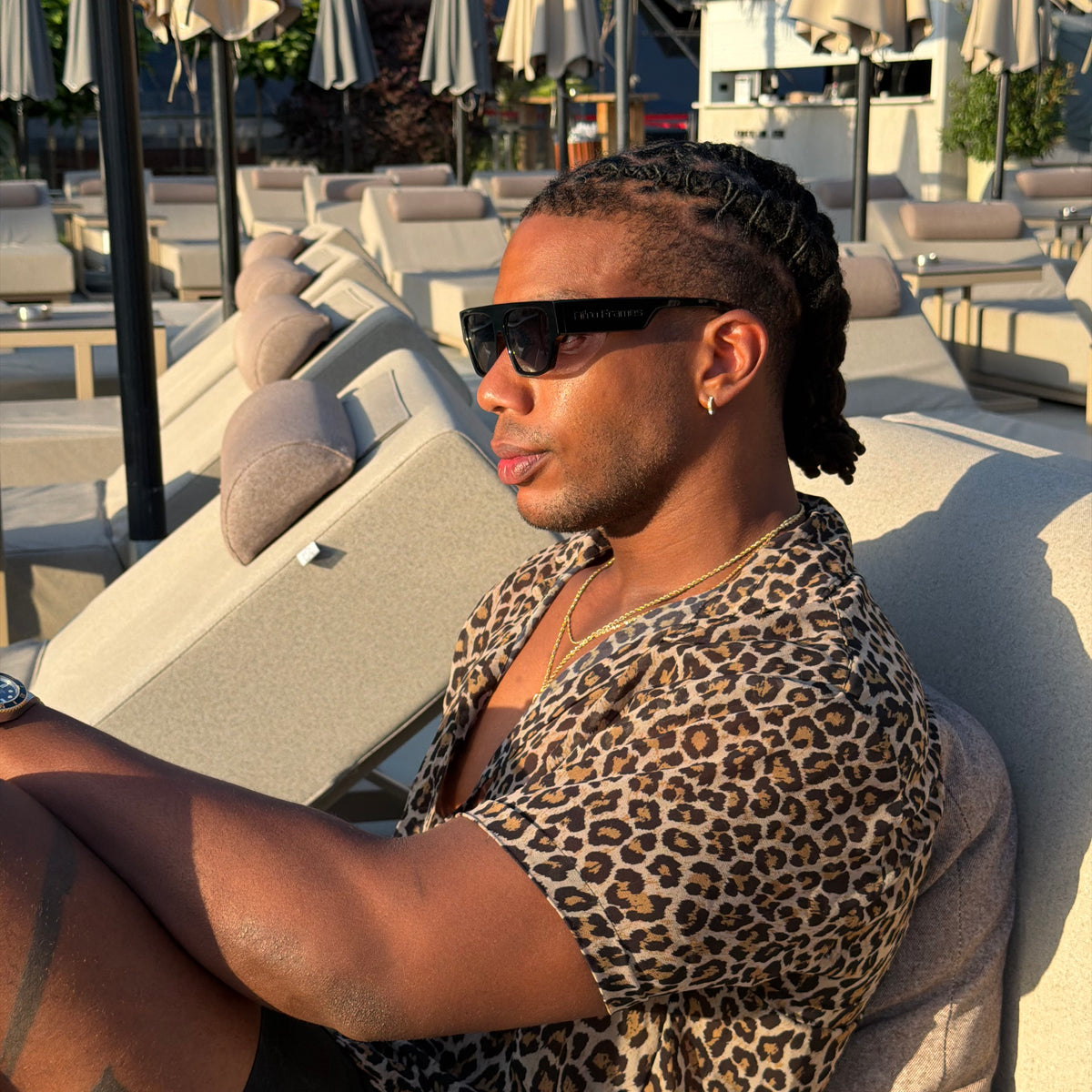Poolside profile — Afro Frames temple engraving over braids