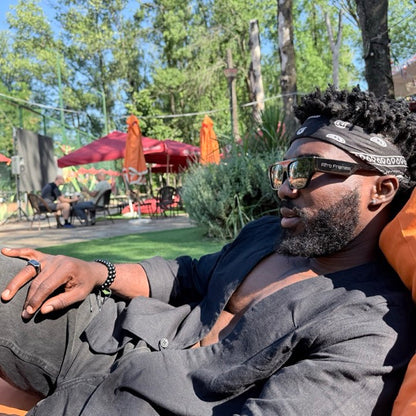 Lounging with the Afro Frames temple logo visible