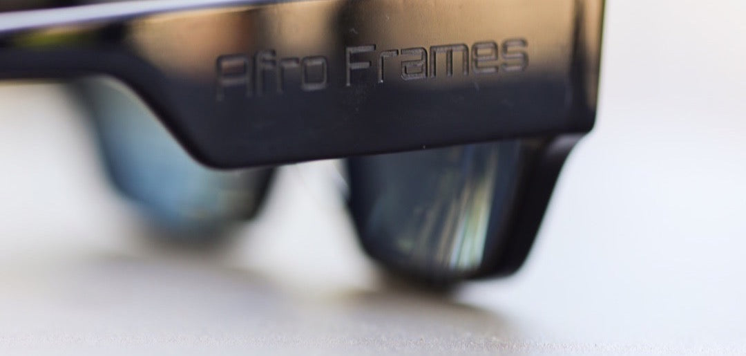 Macro of The Blacked Edition frame showing the tonal laser-engraved Afro Frames logo